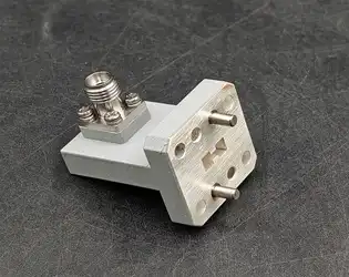 What are the key specifications of a Right Angle Double Ridged WG To Coaxial Adapter?